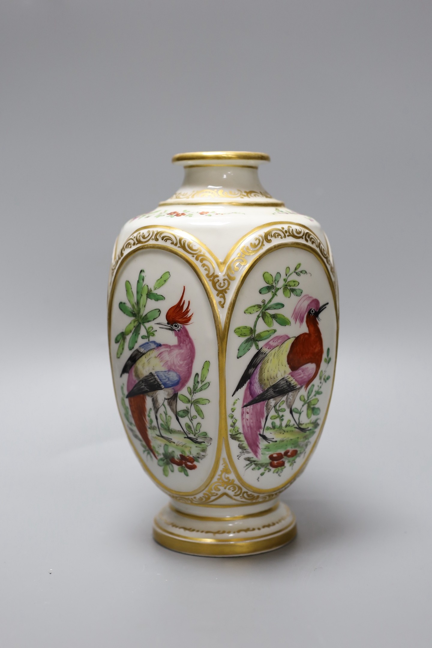 A late 19th century French porcelain vase, in Chelsea style, decorated with birds of paradise, 22 cms high